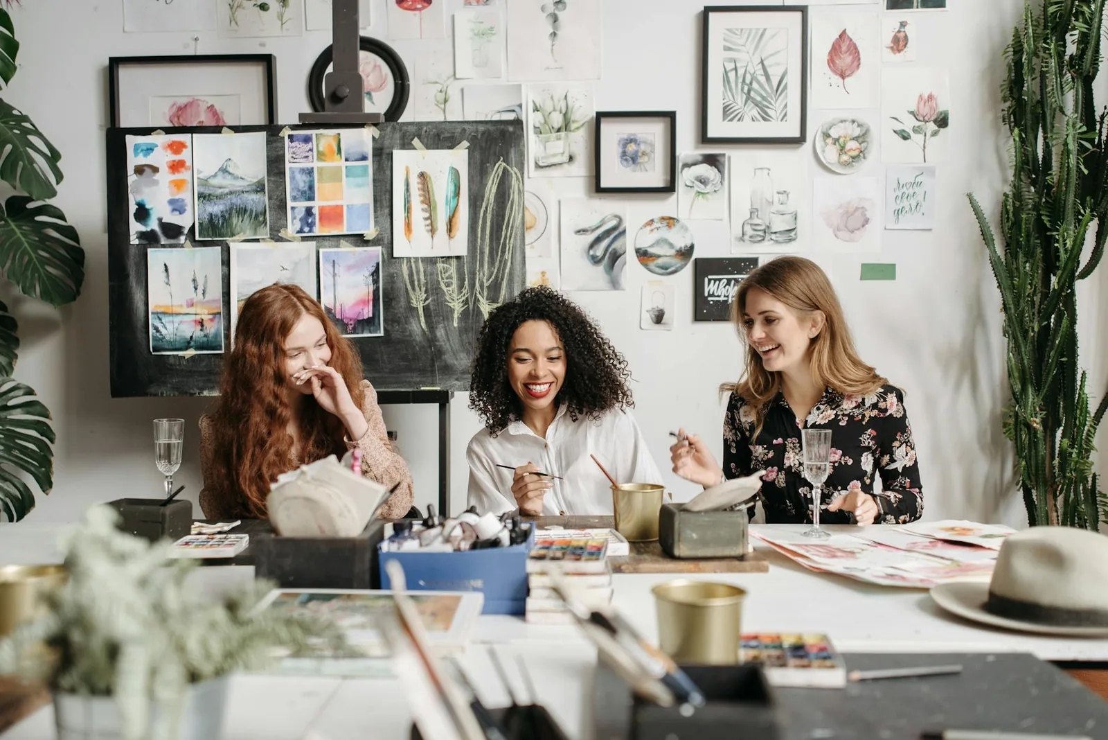Young friends laughing together at a creative craft session